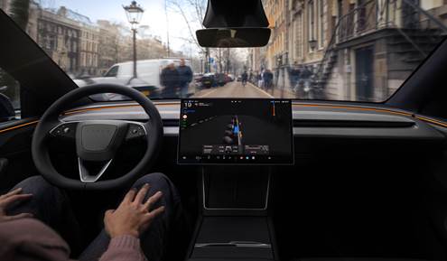 Interior view of an autonomous car showcasing the dashboard with a navigation screen, hands of a driver on the steering wheel, and a street scene visible through the front window.